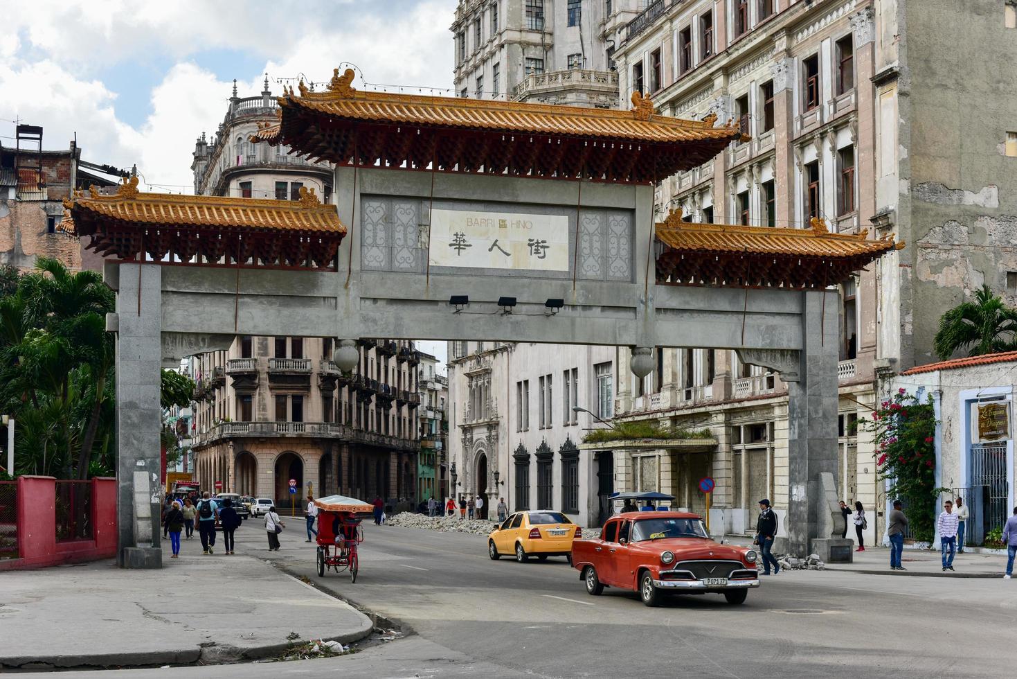 Havana, Cuba - Jan 8, 2017 -  Chinese arch on Calle Dragone in Havana's Barrio Chino. The Chinese arch or gate which is the entrance to the Cuban Chinatown or Barrio Chino in the center of Havana. photo