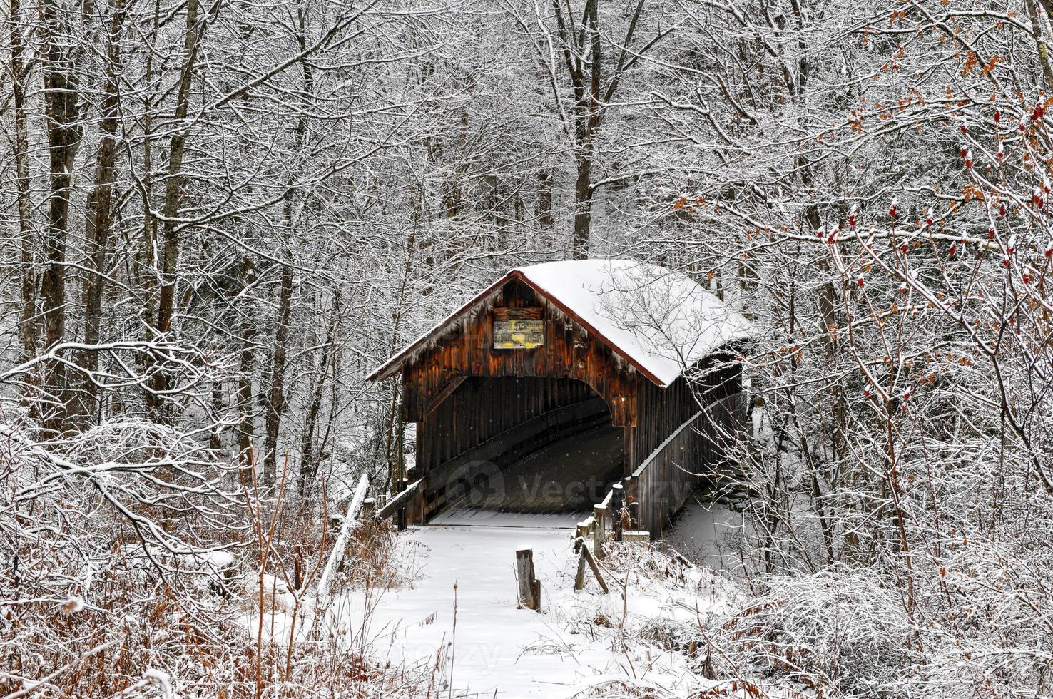 Blacksmith Shop Covered Bridge during the winter in New Hampshire. Built in 1882 it is a historic covered bridge spanning Mill Brook near Town House Road in Cornish, New Hampshire, United States. photo