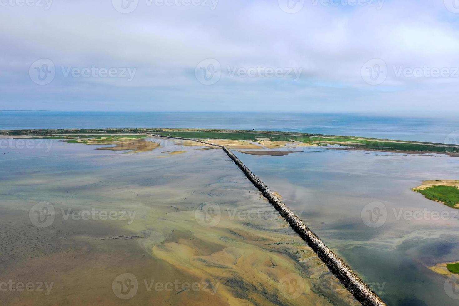 Provincetown Causeway also known as the Breakwater Walk, is an uneven collection of rocks that allows hikers to cross the harbor and reach the very tip of the Cape. photo