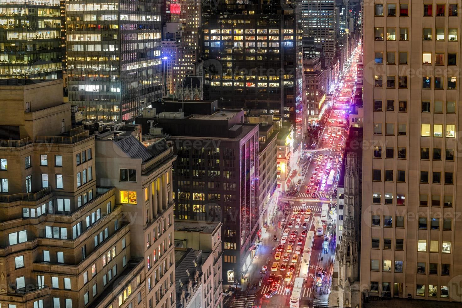 New York City skyline in midtown Manhattan as cars drive through the city in the evening. photo