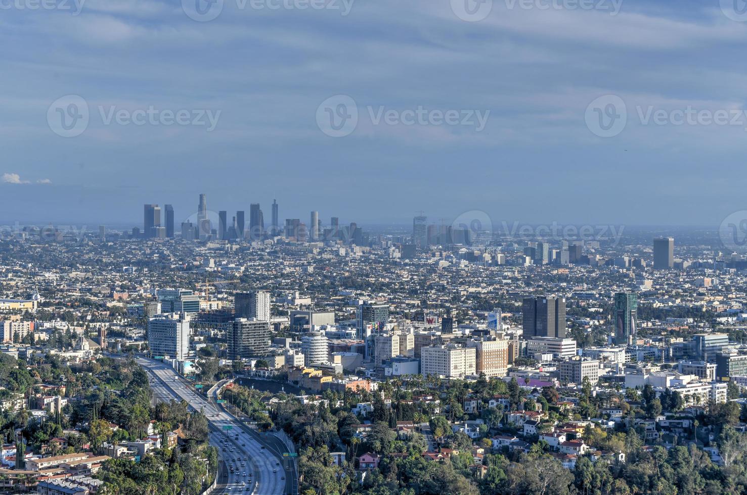 Downtown Los Angeles skyline over blue cloudy sky in California from Hollywood Hills. photo