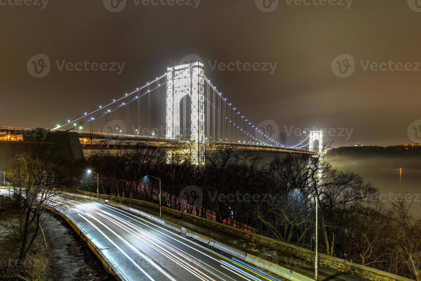 George Washington Bridge fully illuminated at night from New York City photo