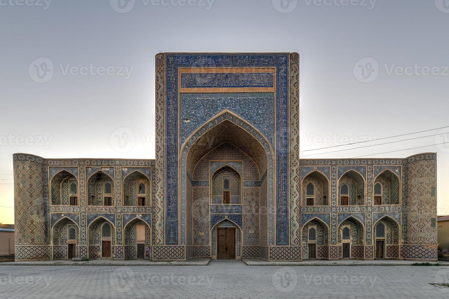 Abdullah Khan Madrassah boasts the perfectly decorated courtyard with the blue tiled traceries on the walls in Bukhara, Uzbekistan. photo