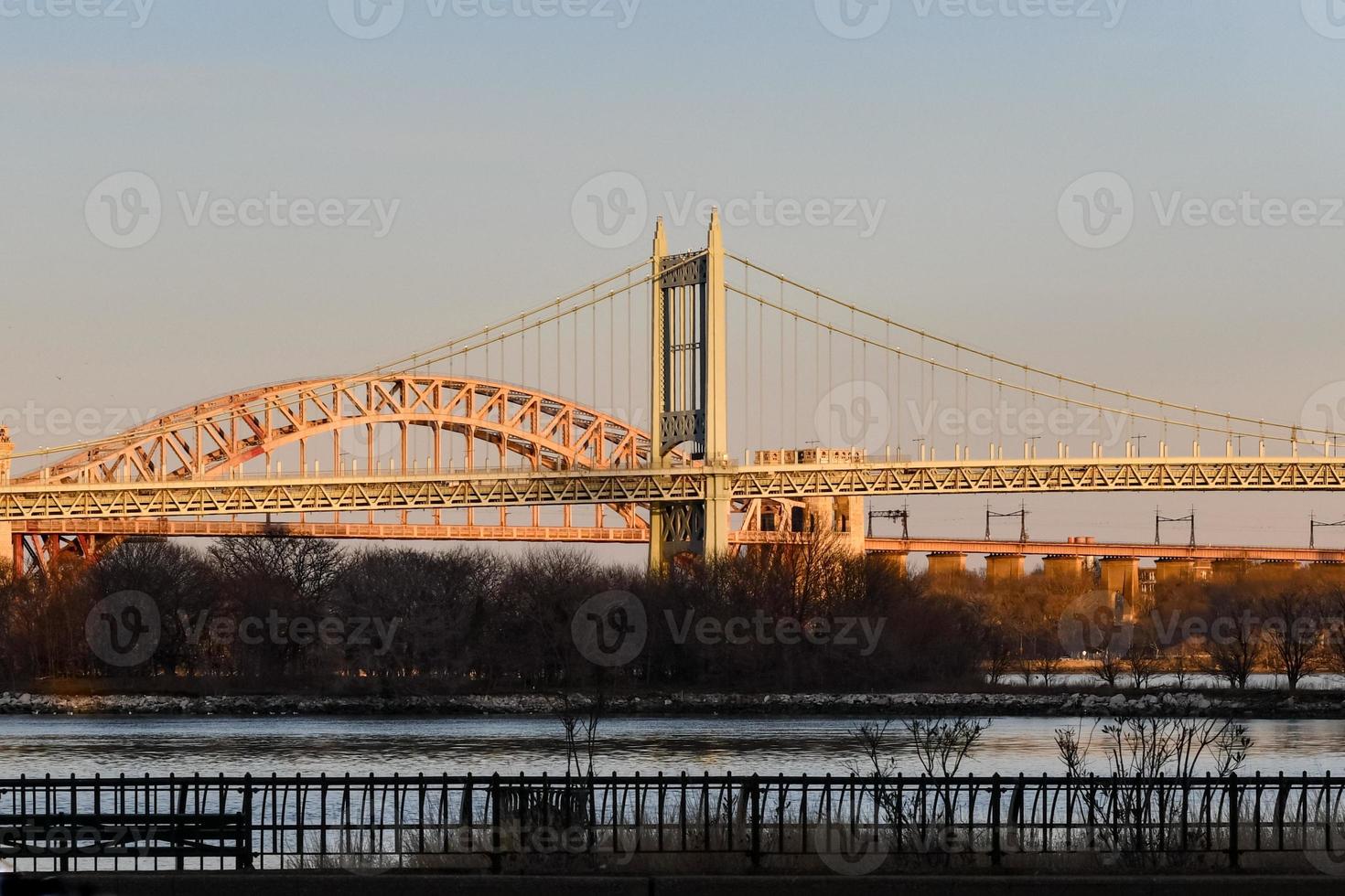 Triborough and Hell Gate Bridge at sunset from the East Side of Manhattan, New York City. photo