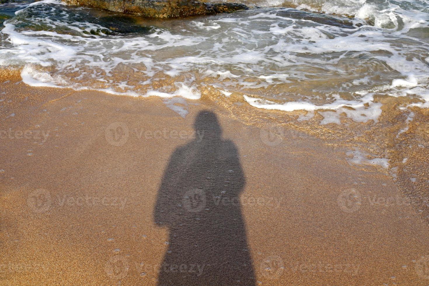 Photographer's shadow on the seashore. photo