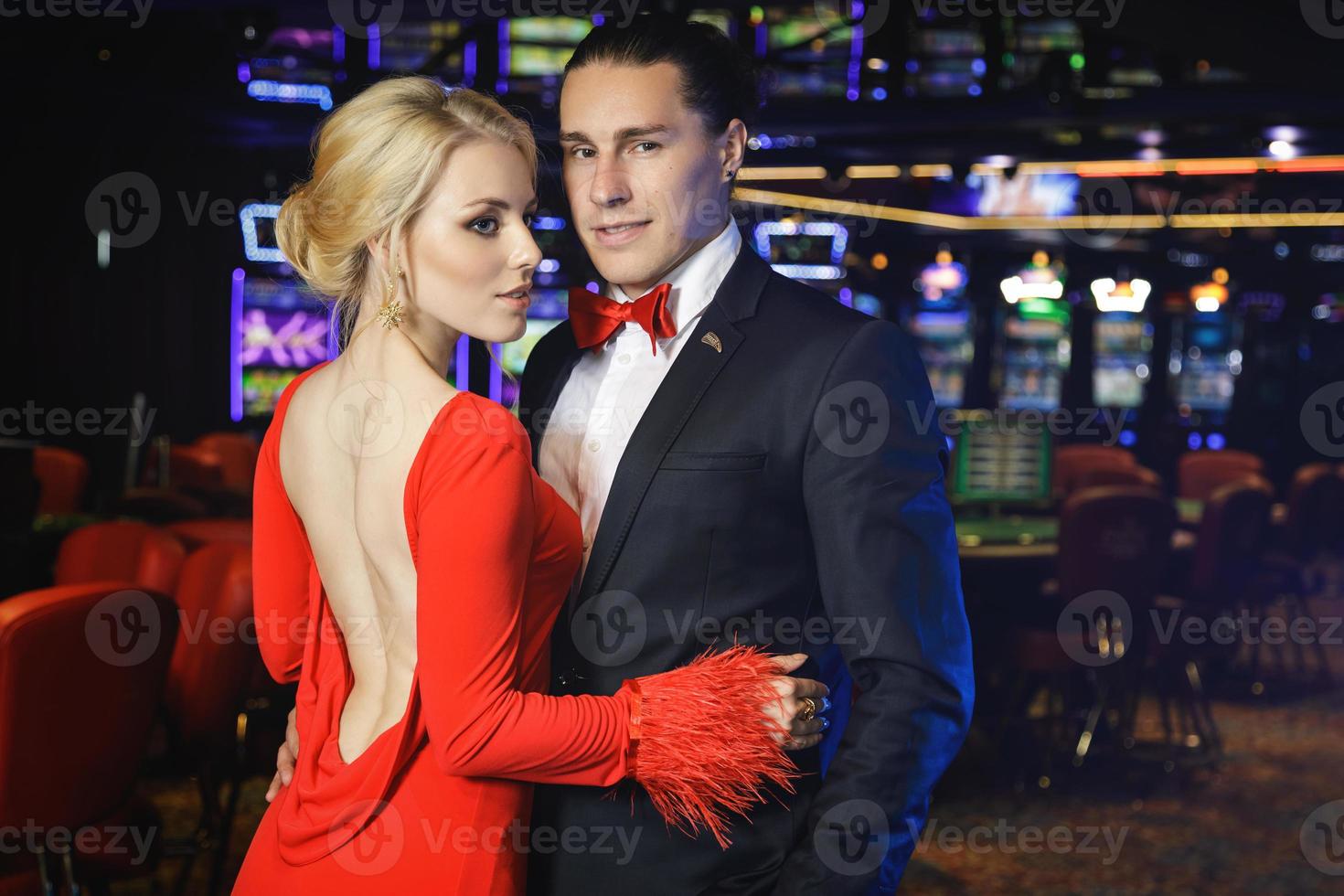 Young and beautiful and well dressed couple in the casino photo