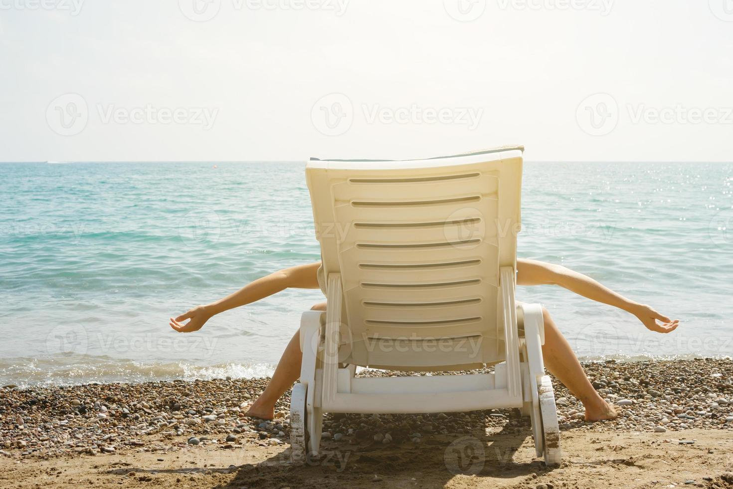 Woman lying on the sunbed in funny pose photo