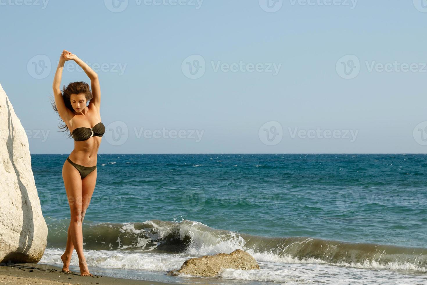 Woman on the beach beside white cliffs photo