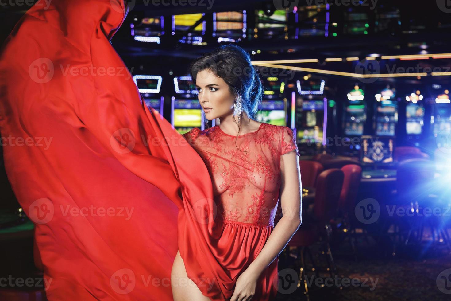 Beautiful woman wearing red dress in the casino photo