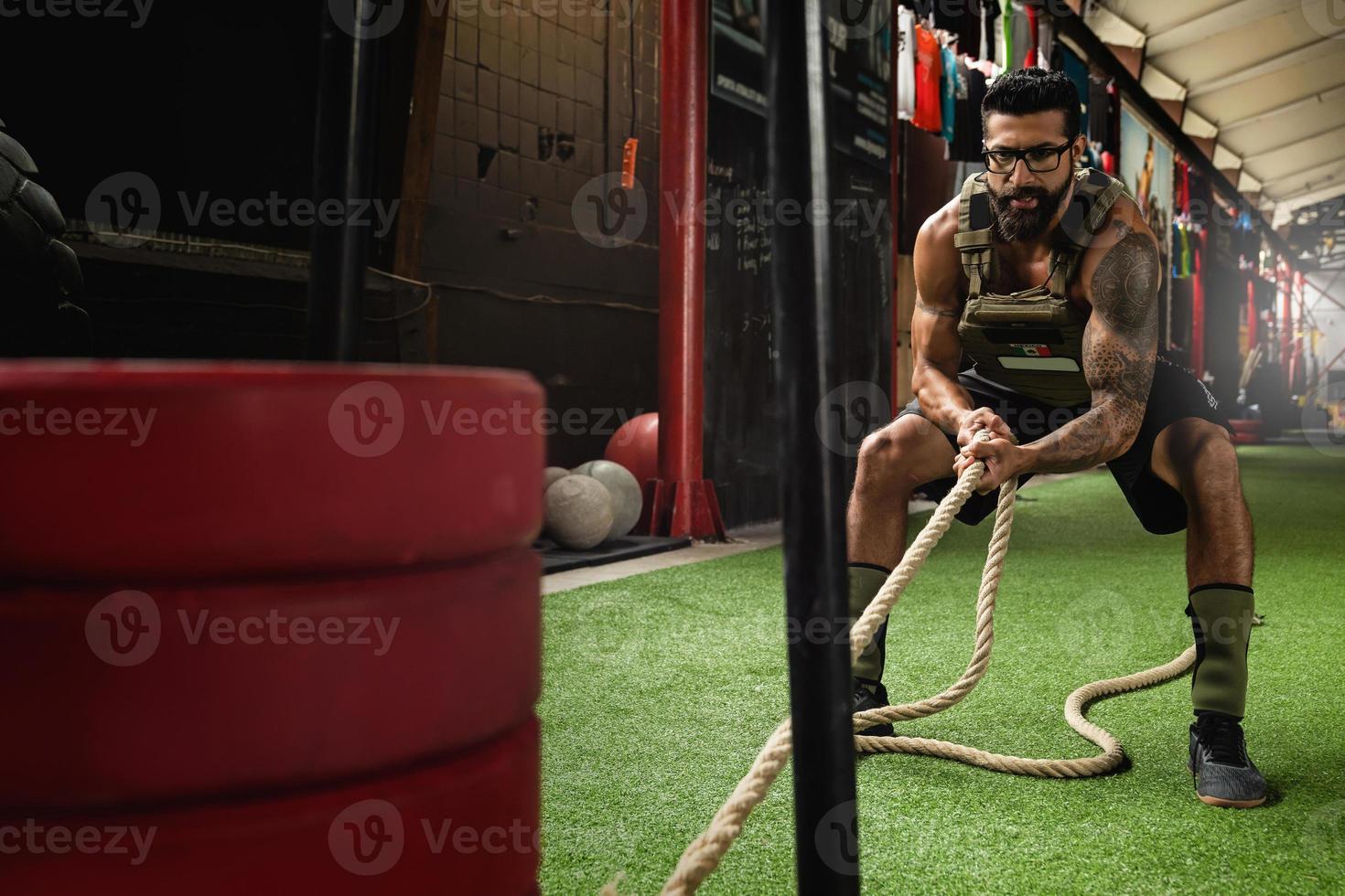 Sled drag exercise. Sportsman during his cross training workout. photo