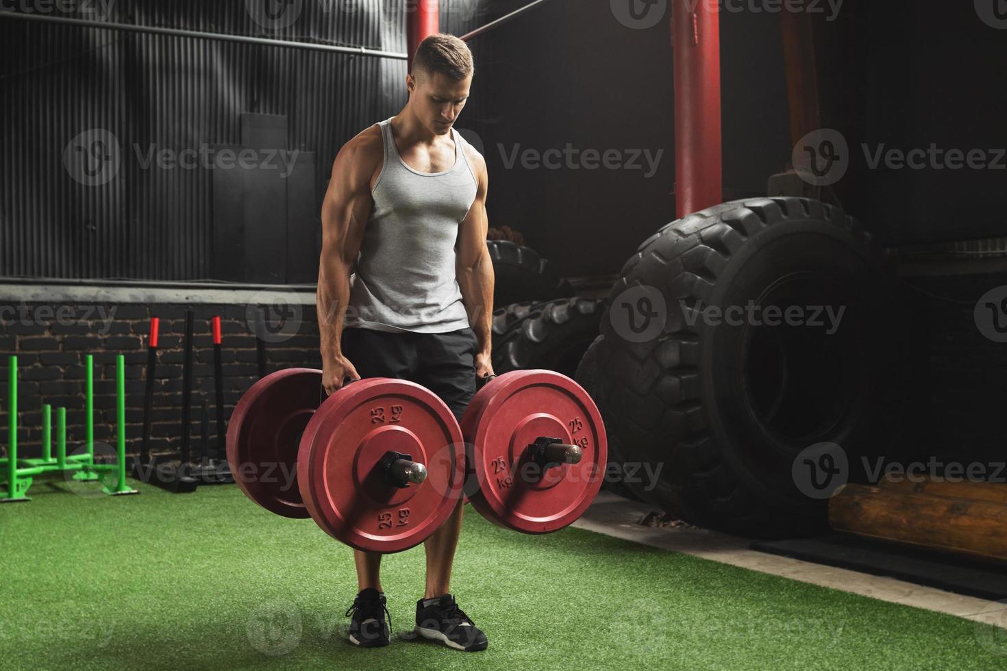 Sportsman doing farmer's walk exercise during his cross training workout photo