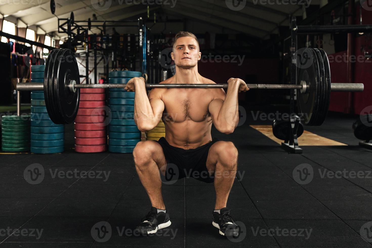 Muscular man during his weightlifting workout in the gym photo