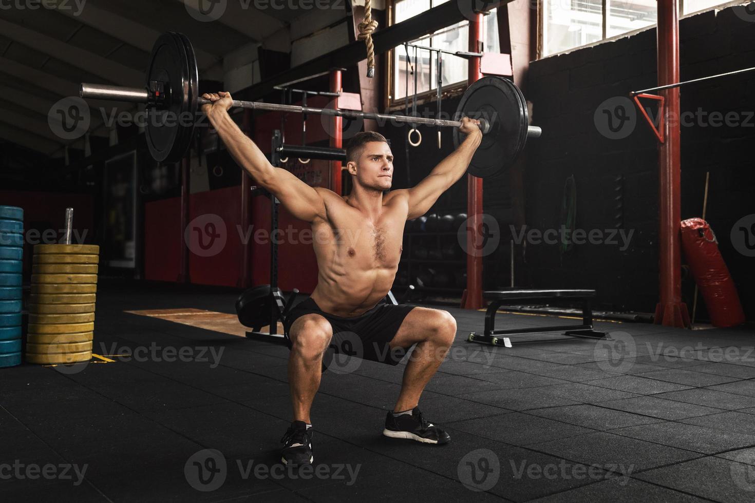 Muscular man during his weightlifting workout in the gym photo