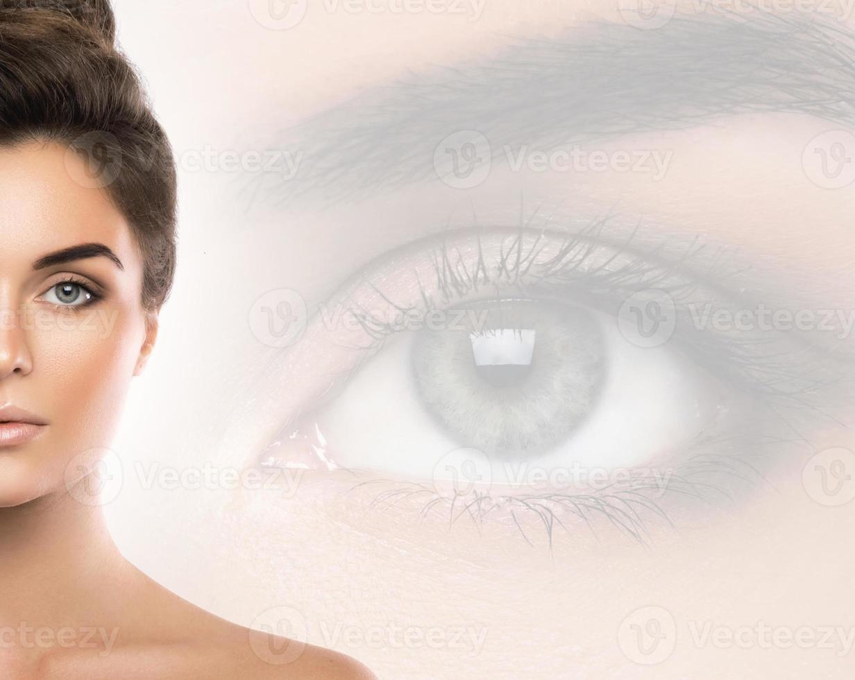 Beautiful woman and eye closeup on background photo