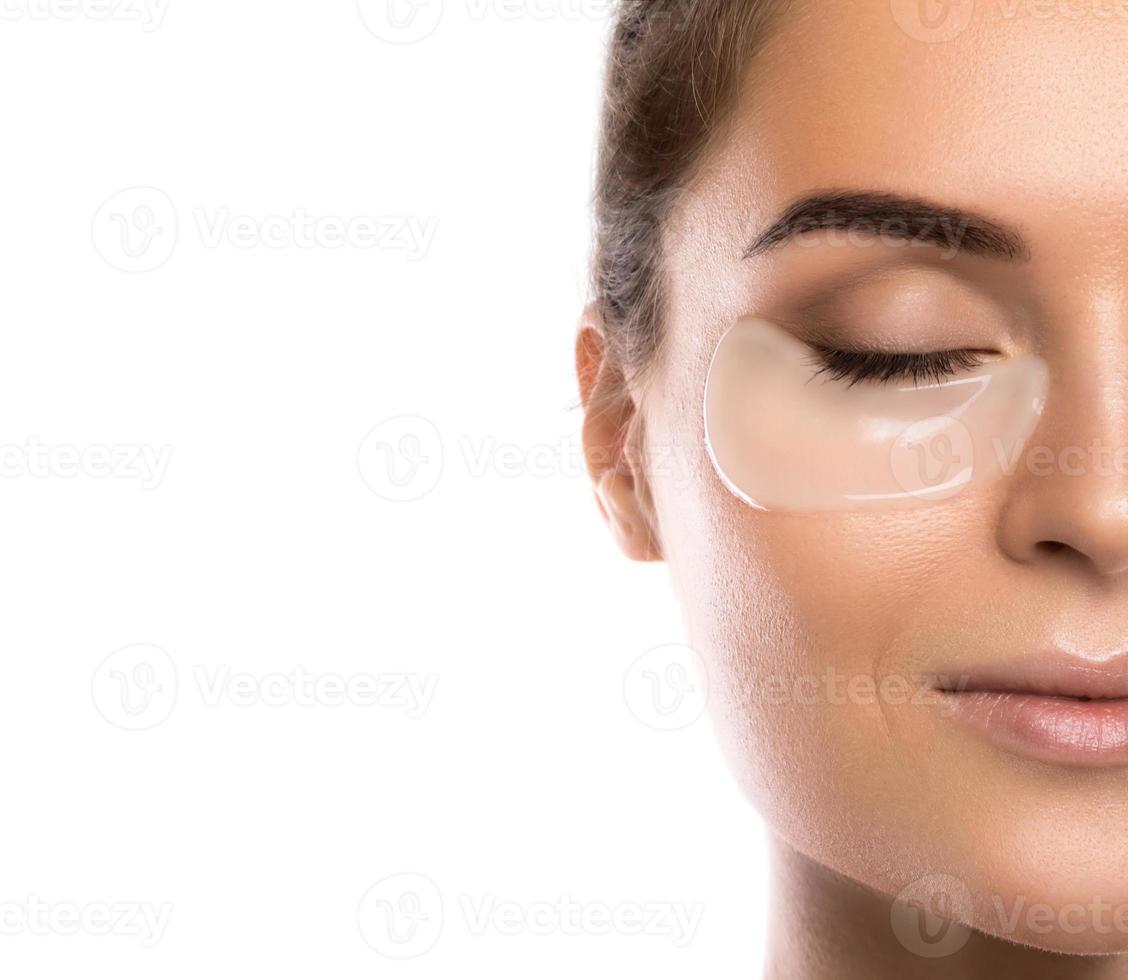 Woman with collagen pads under her eyes photo