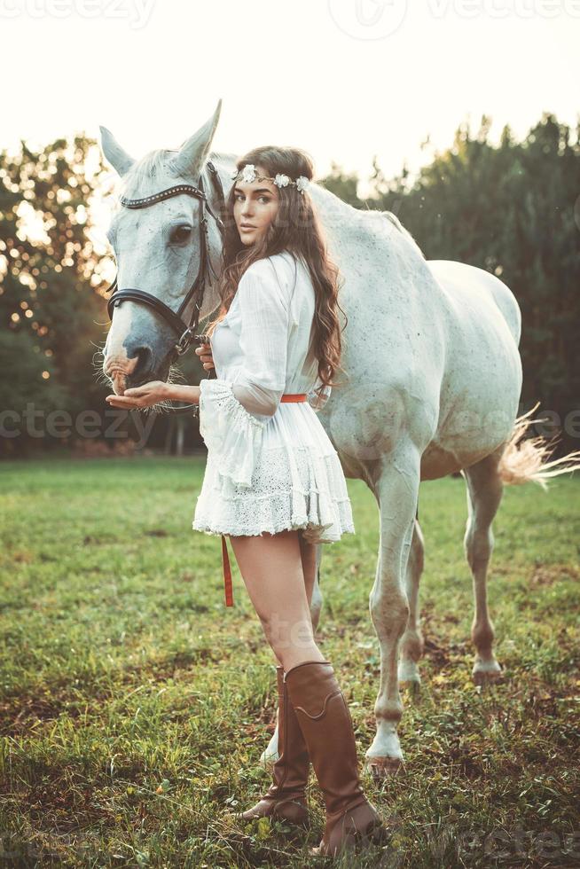 Woman in beautiful white dress and her beautiful horse photo