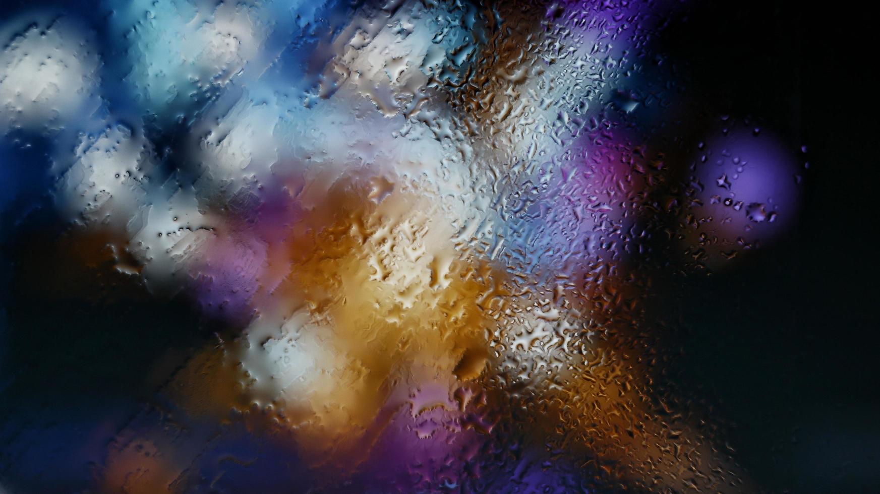 Purple Neon Blurred Lights Through Glass Window With Raindrops On It in Karachi Pakistan 2022 photo