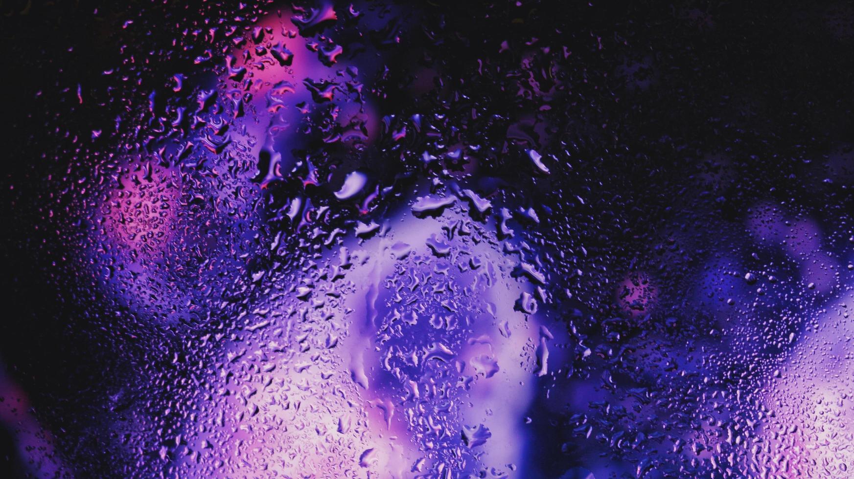 Purple Neon Blurred Lights Through Glass Window With Raindrops On It in Karachi Pakistan 2022 photo