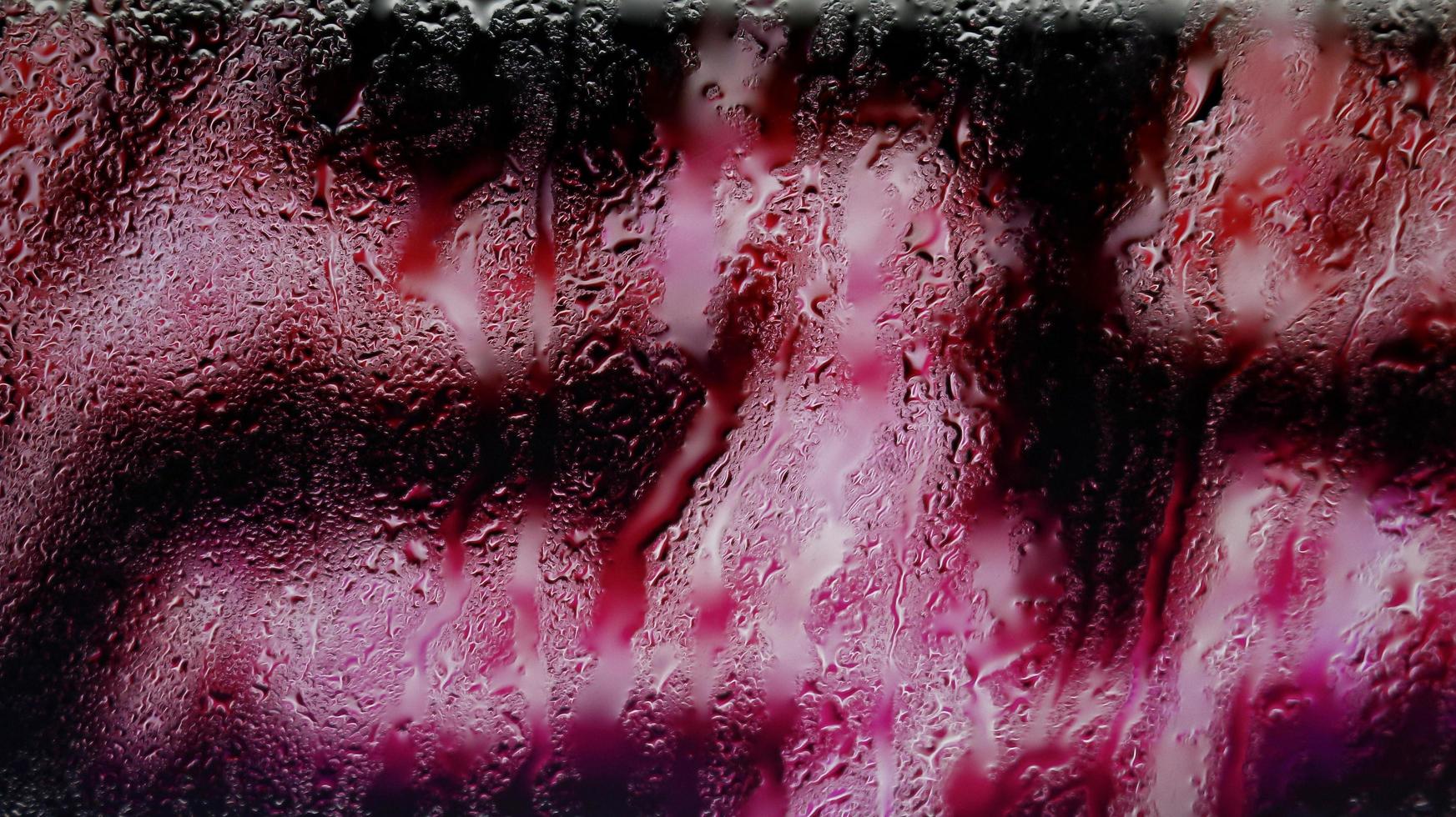 Purple Neon Blurred Lights Through Glass Window With Raindrops On It in Karachi Pakistan 2022 photo