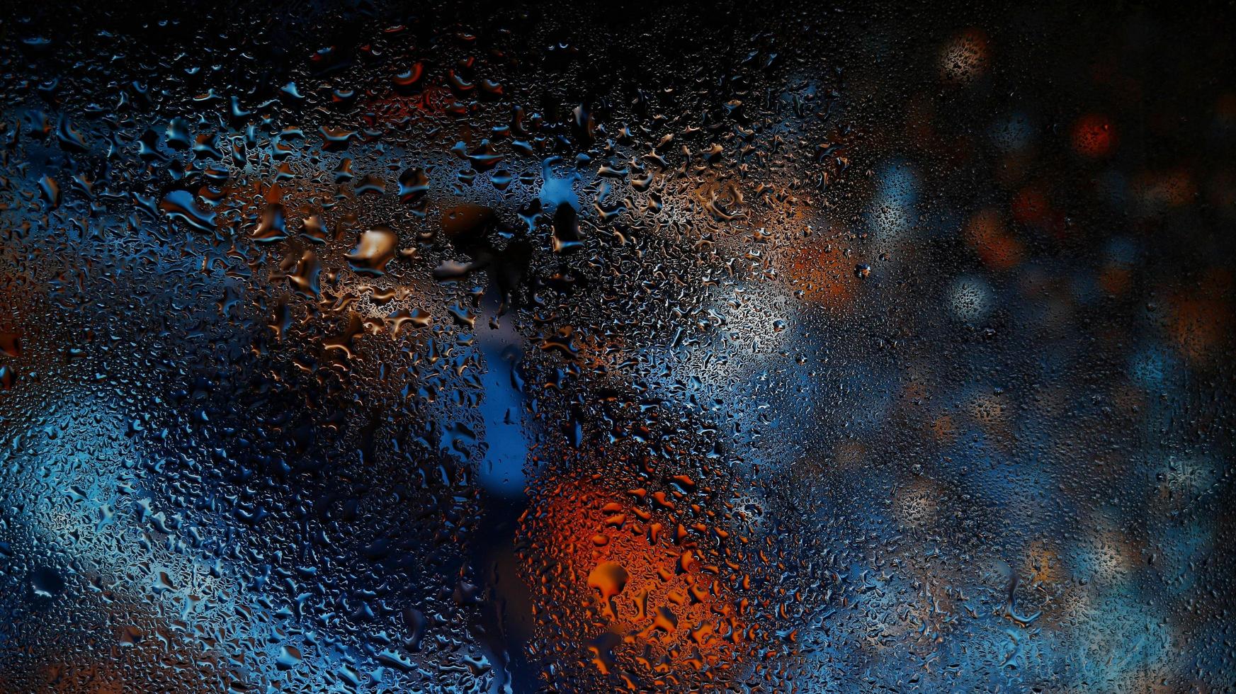 Purple Neon Blurred Lights Through Glass Window With Raindrops On It in Karachi Pakistan 2022 photo