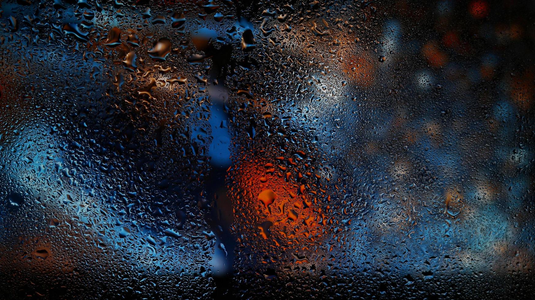 Purple Neon Blurred Lights Through Glass Window With Raindrops On It in Karachi Pakistan 2022 photo
