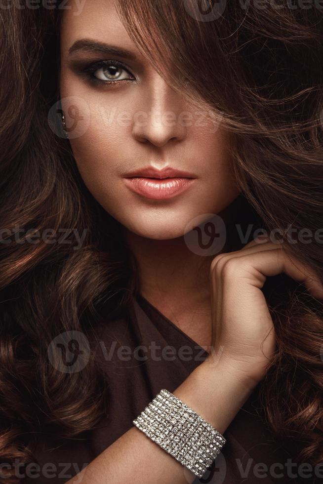 Portraif of beautiful woman with shiny bracelet photo