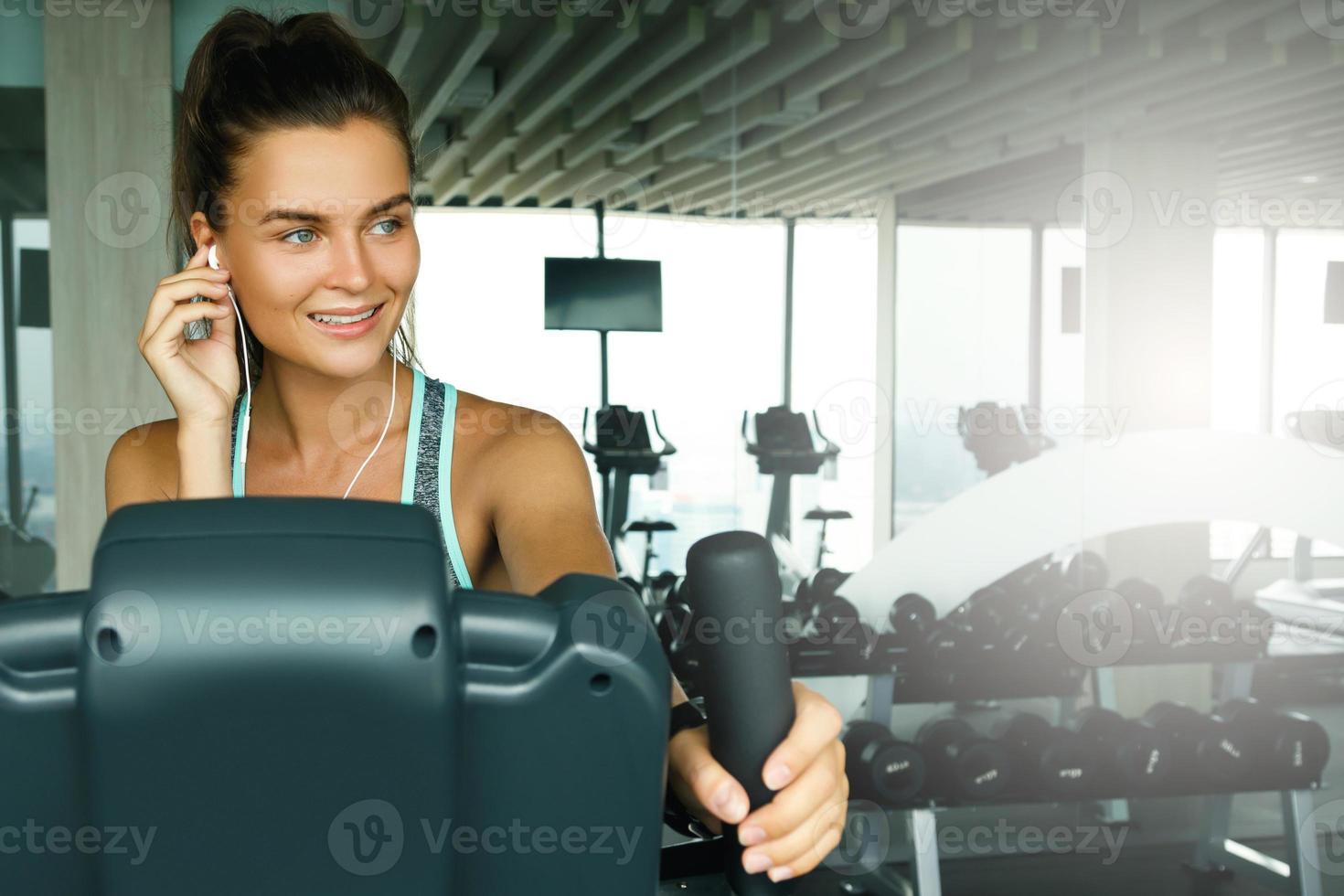 Woman is listening music during her workout photo