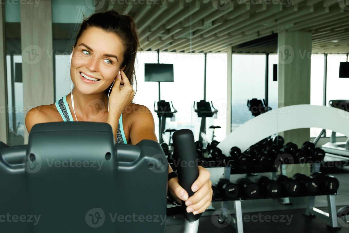 Woman is listening music during her workout photo