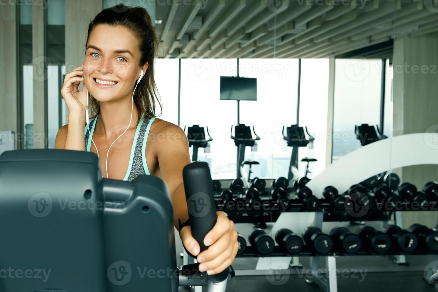 Woman is listening music during her workout photo