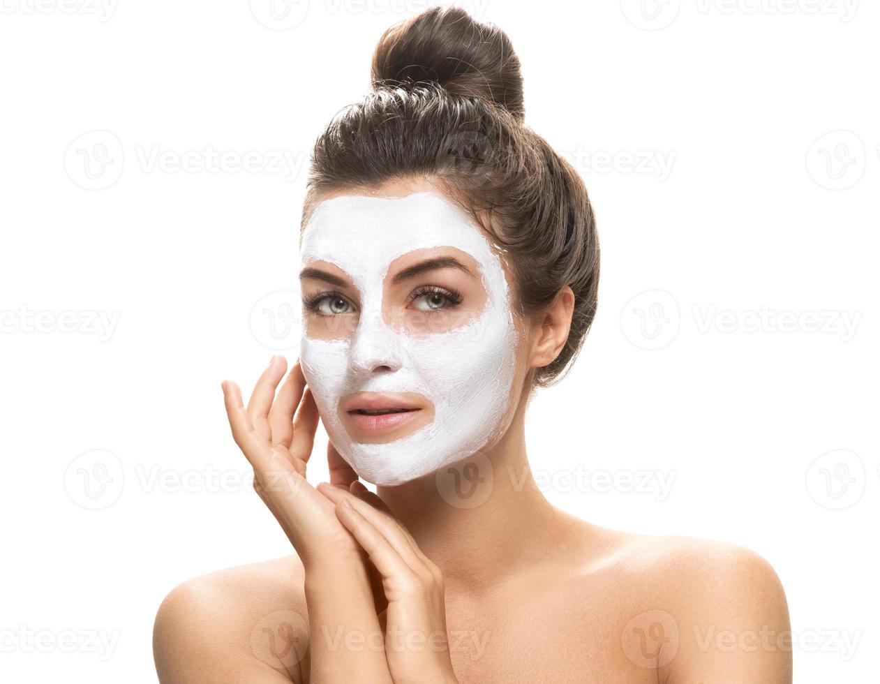 Woman with facial mask on white background photo