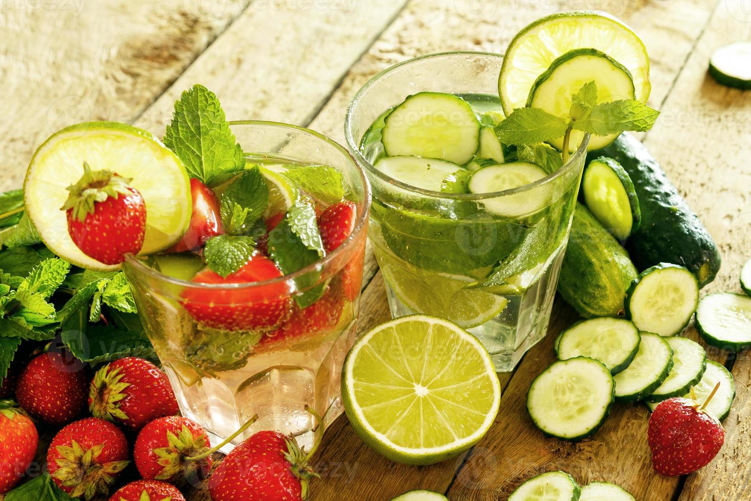 Refreshing drink with strawberry, lime and cucumber photo
