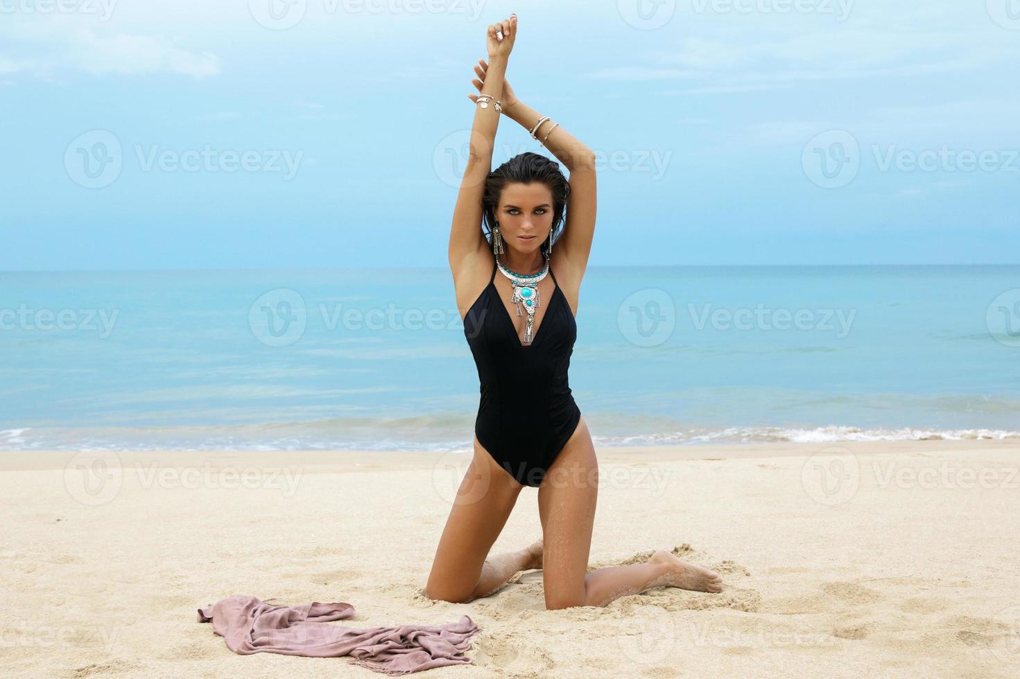 Woman wearing silver jewelry on the beach photo