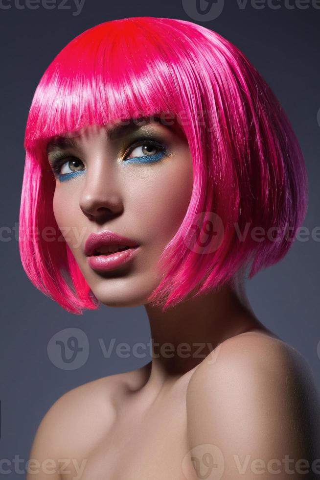 Potrait of young woman with pink hair photo