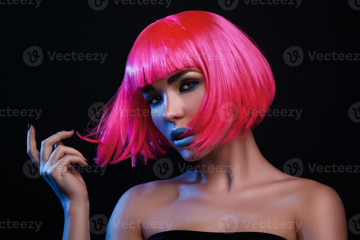 Potrait of young woman with pink hair photo