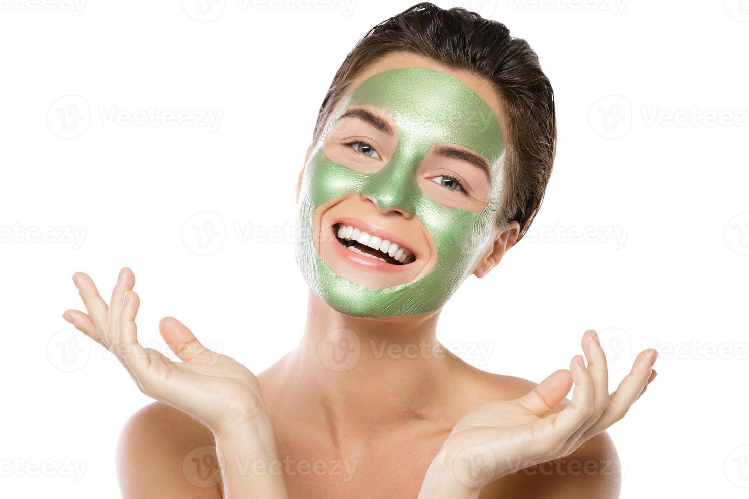 Woman with green peel-off mask on her face photo