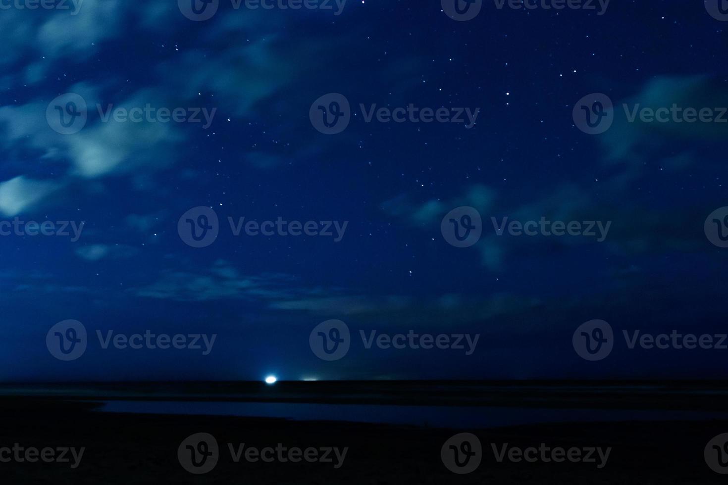 Night sky with stars and clouds in motion photo
