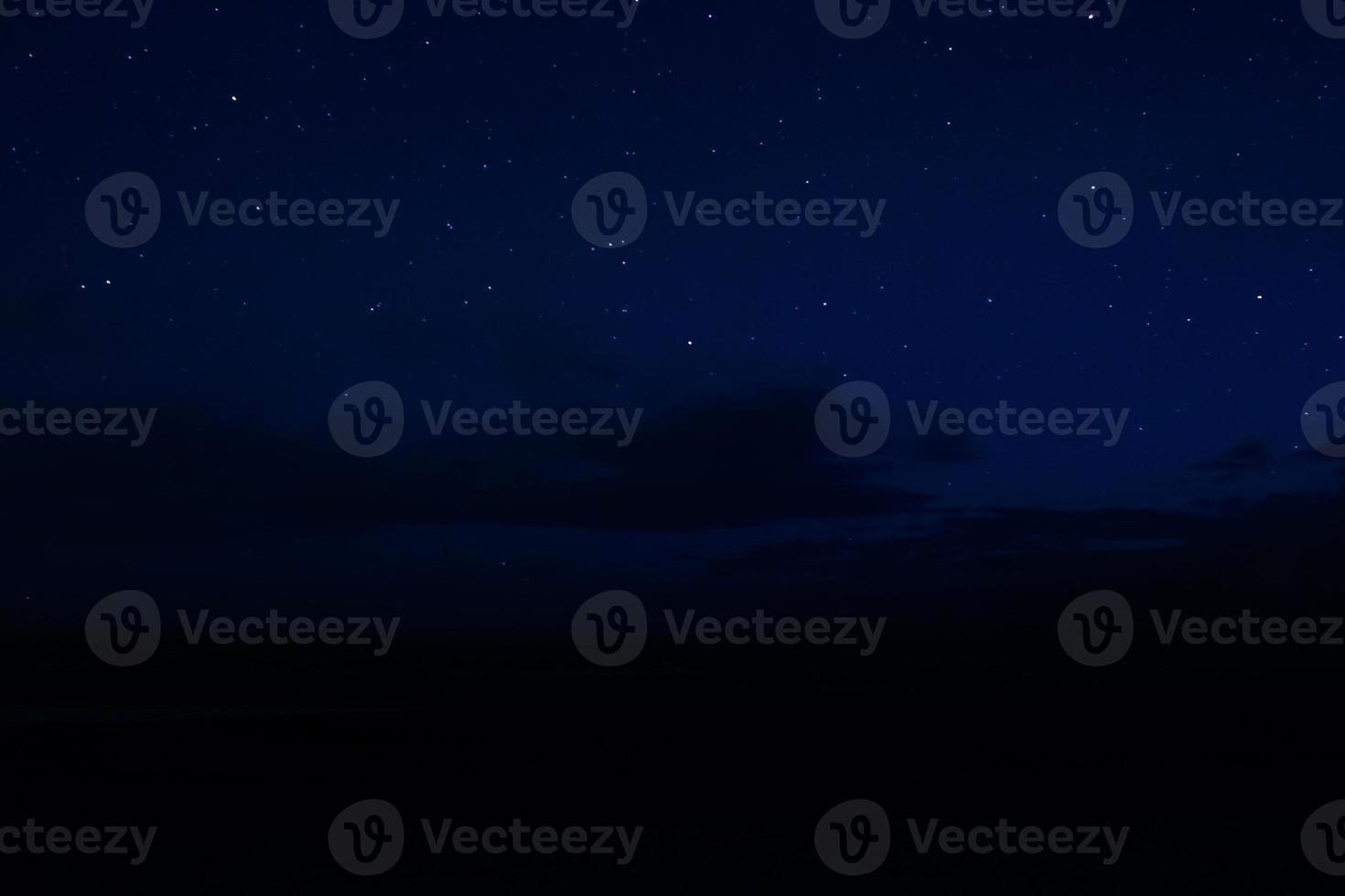 Night sky with stars and clouds in motion photo