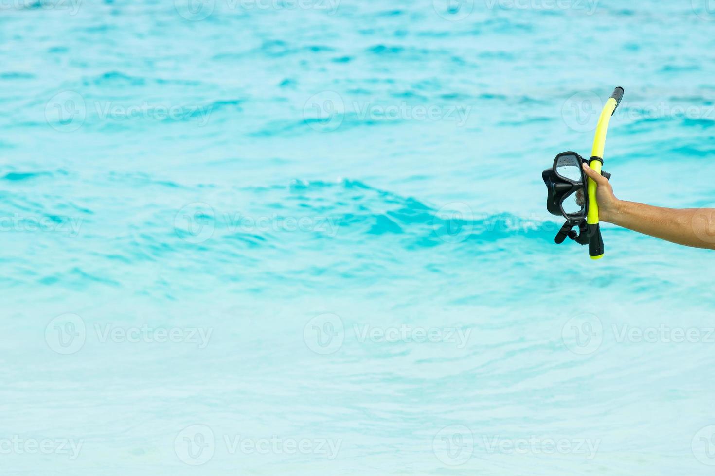 Hand with a mask for snorkeling photo