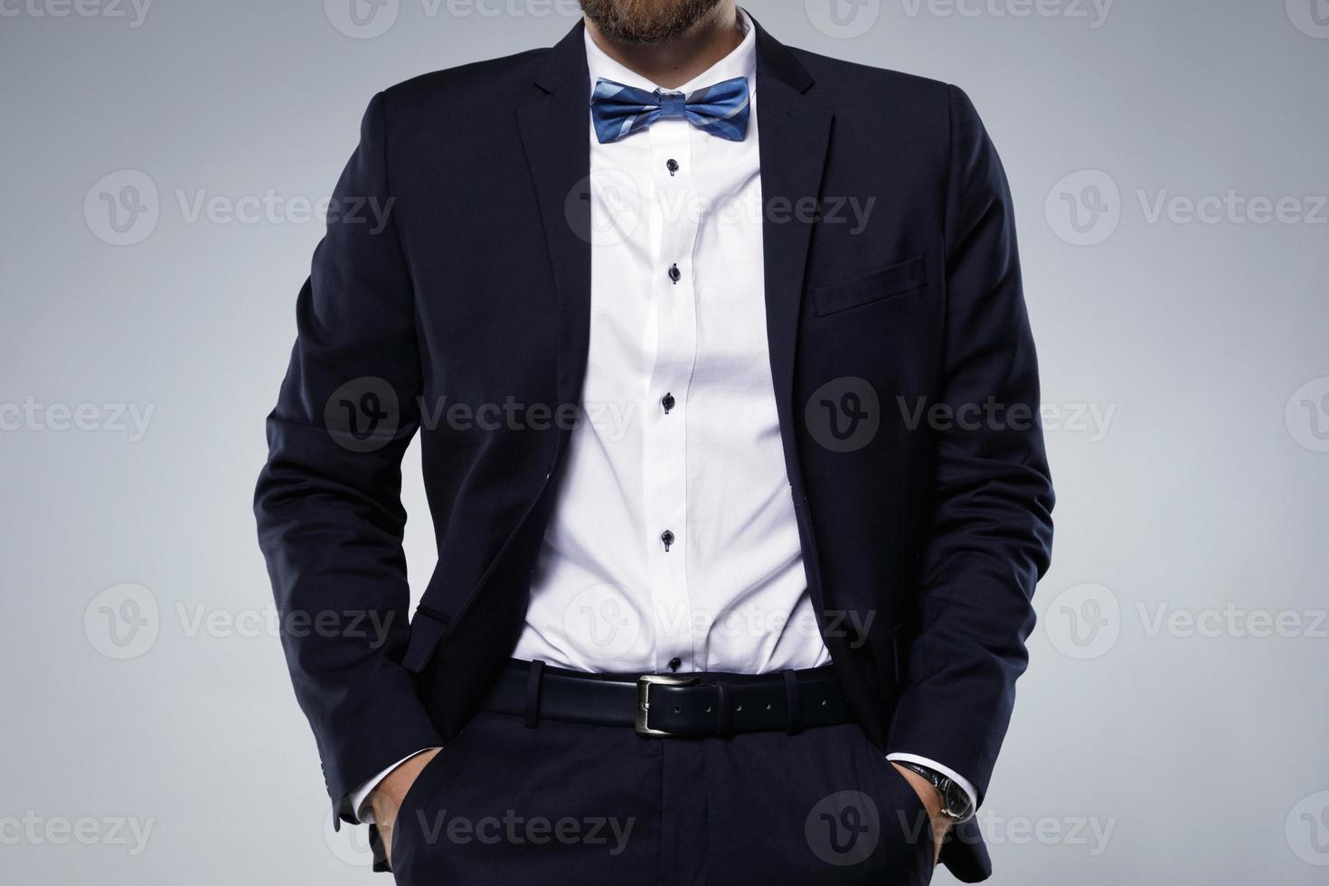 Man in navy blue suit with bow tie photo