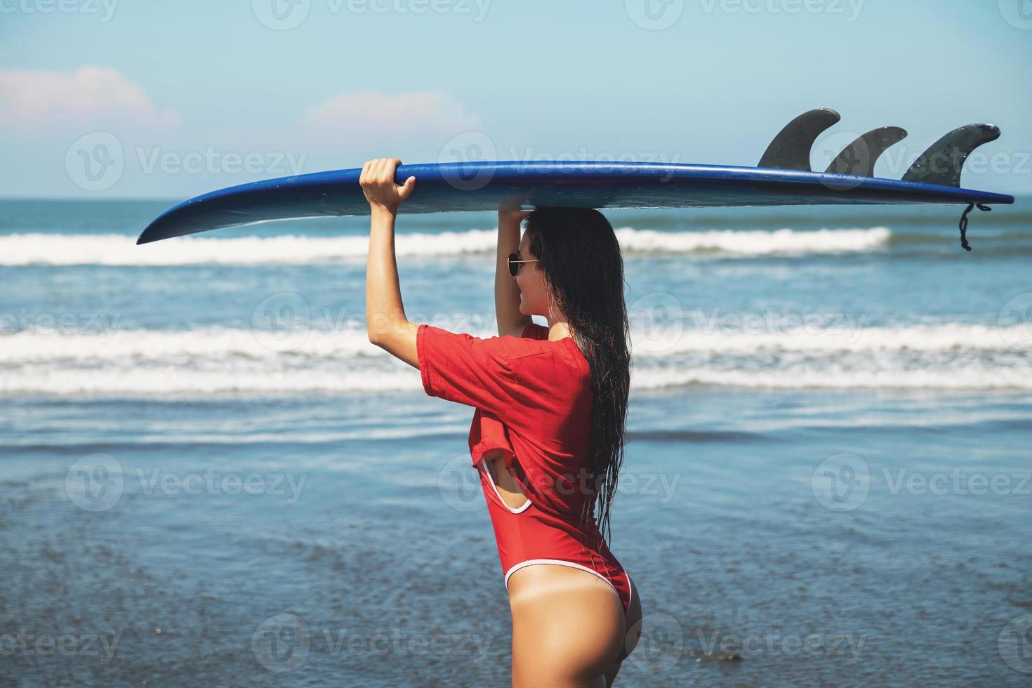 Sexy woman surfer with shortboard on the beach photo