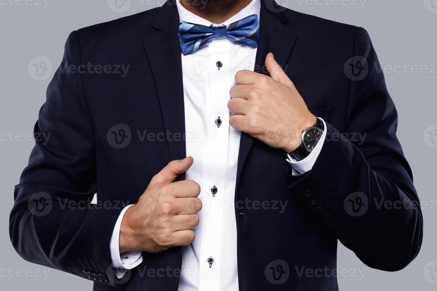 Man in navy blue suit with bow tie photo