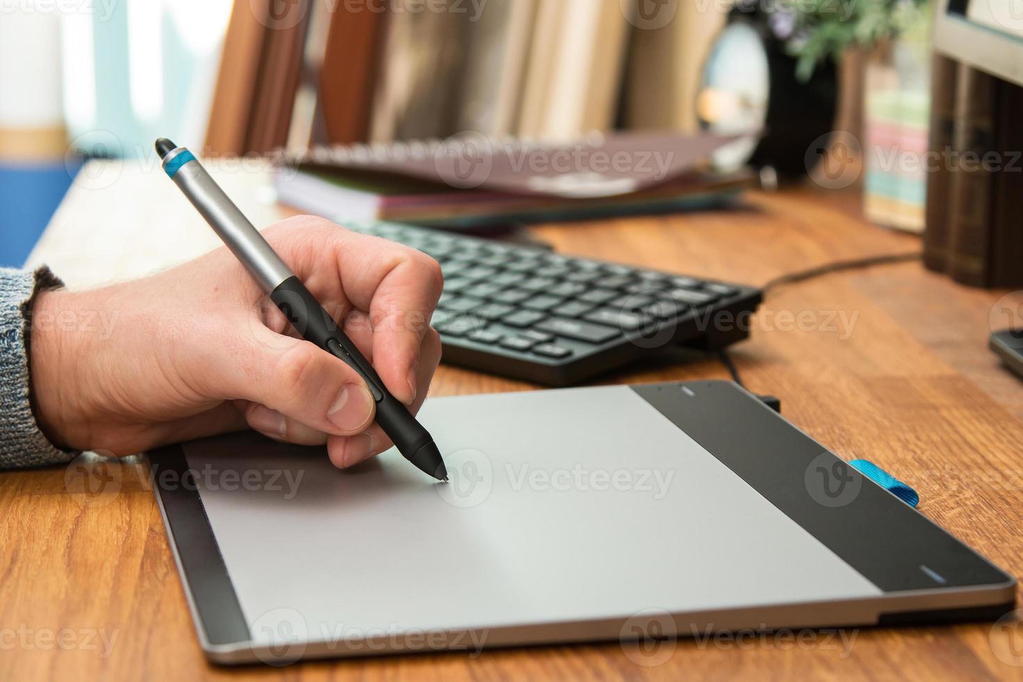 Closeup of male hands during using a graphic tablet photo