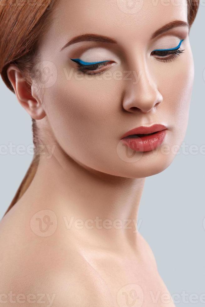 Woman with blue eyeliner on her eyes photo