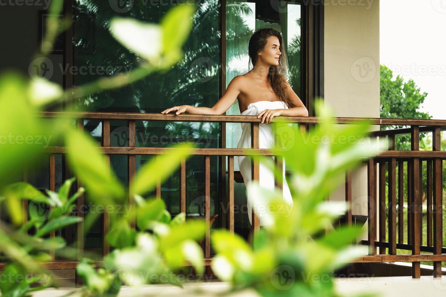Beautiful woman on the balcony after shower photo