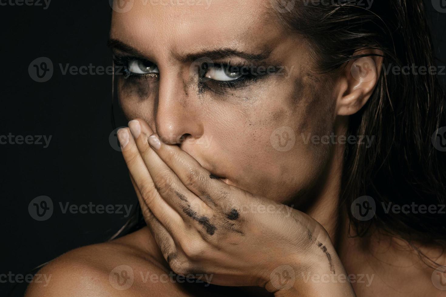 Beautiful woman with smudged makeup on her face photo