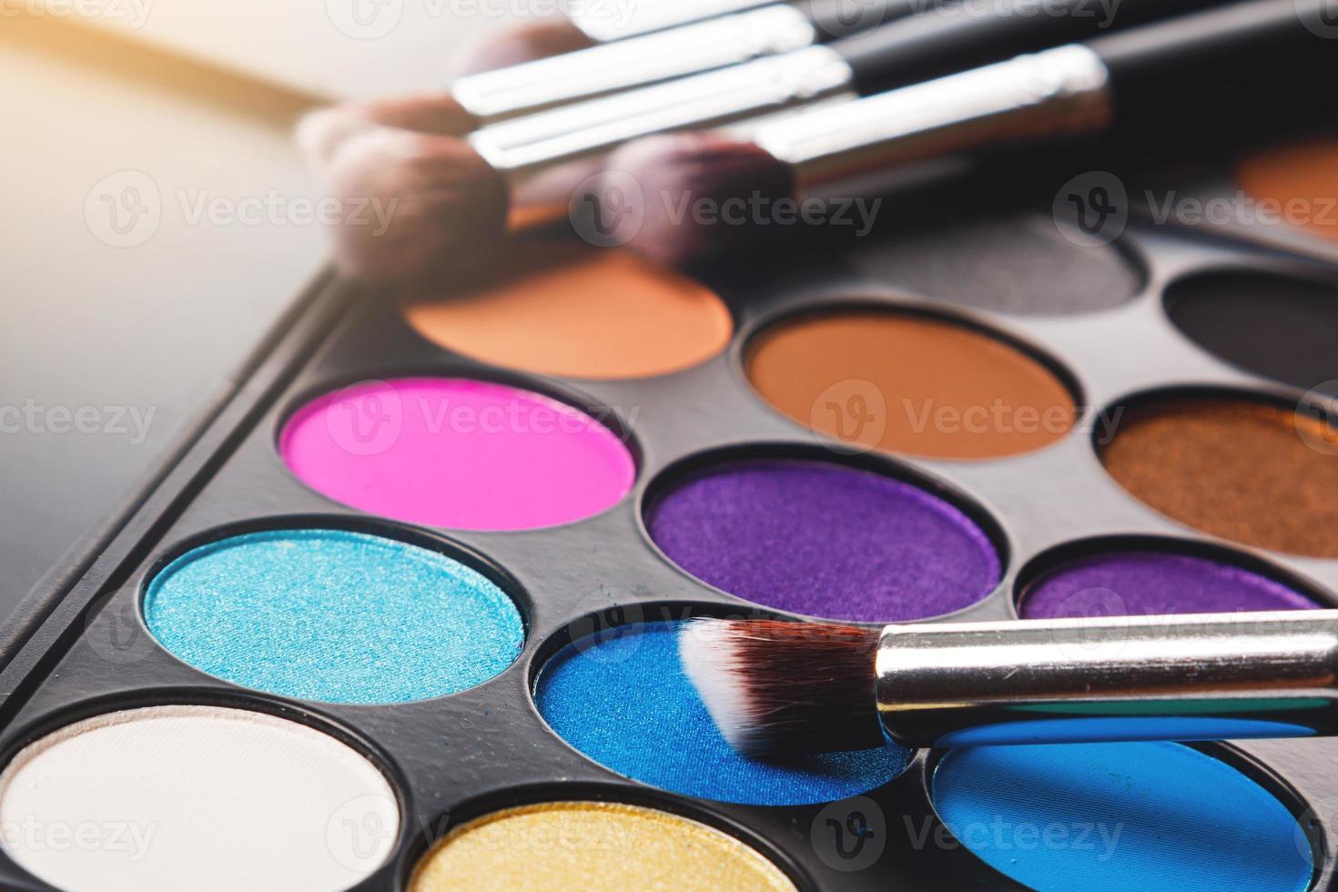 Close up of eyeshadow palette and brushes photo