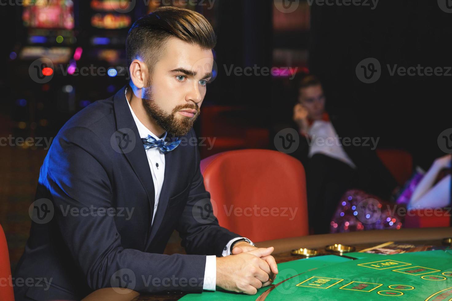 Well dressed man playing cards in the casino photo