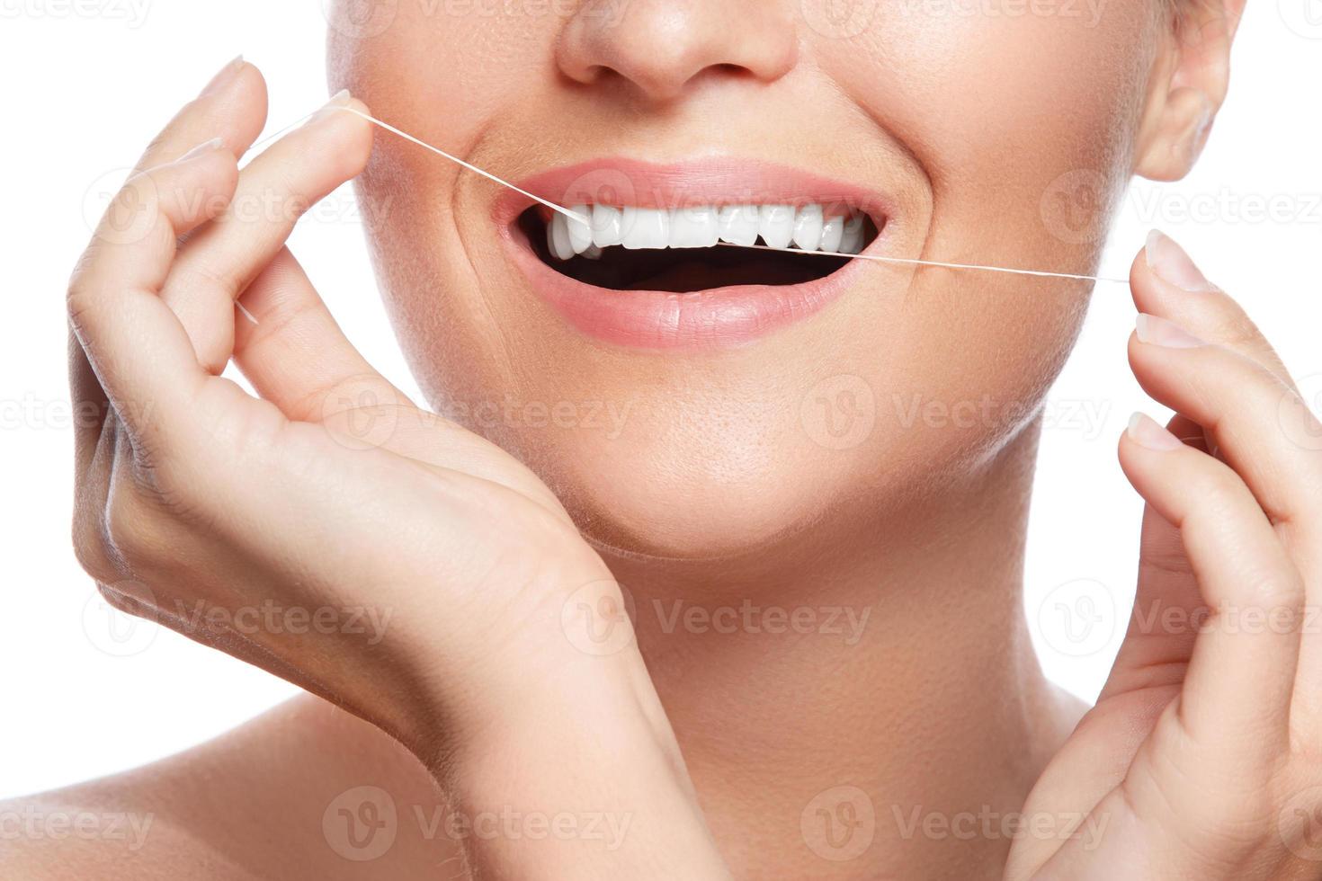 Woman and dental floss on white background photo