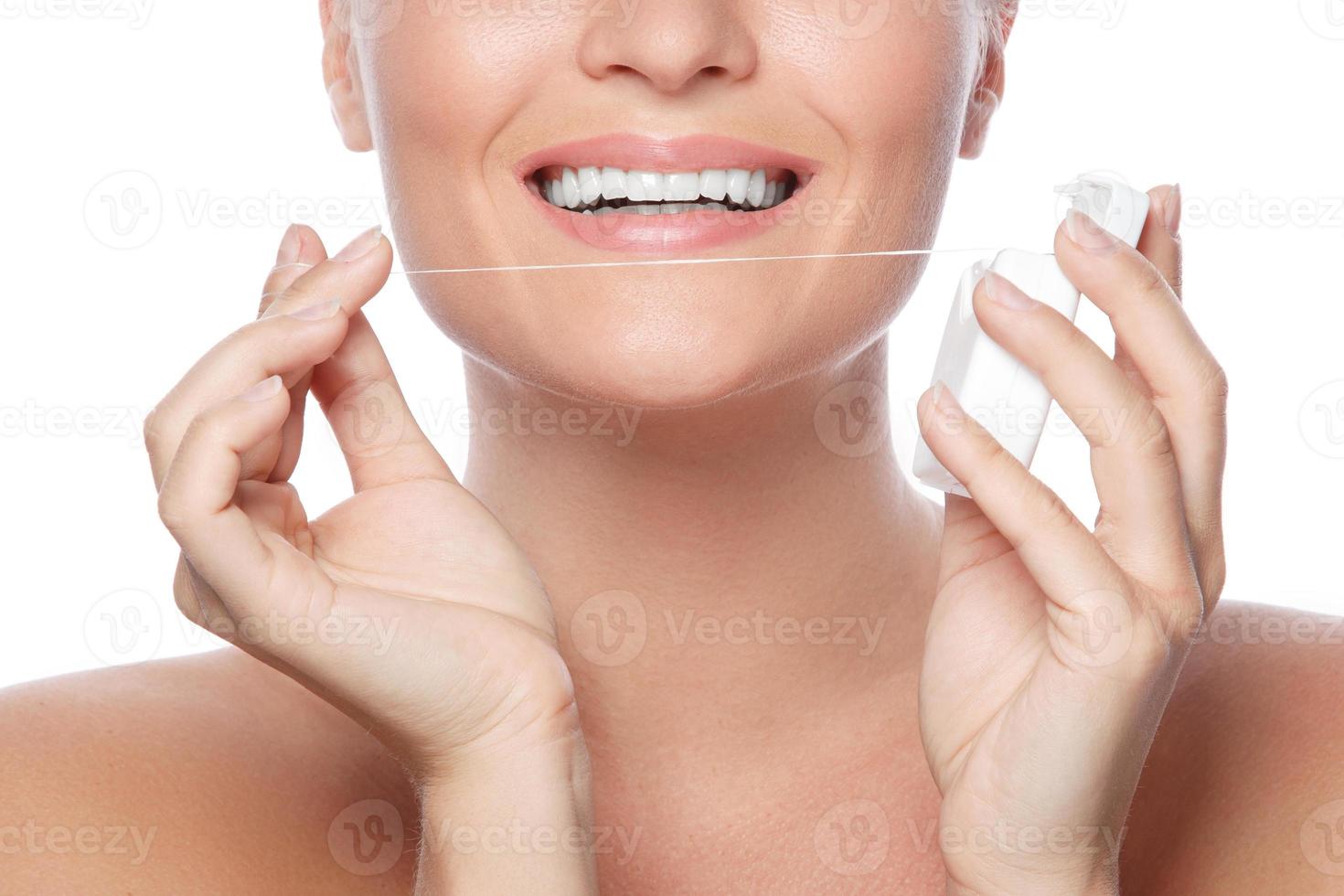 Woman and dental floss on white background photo