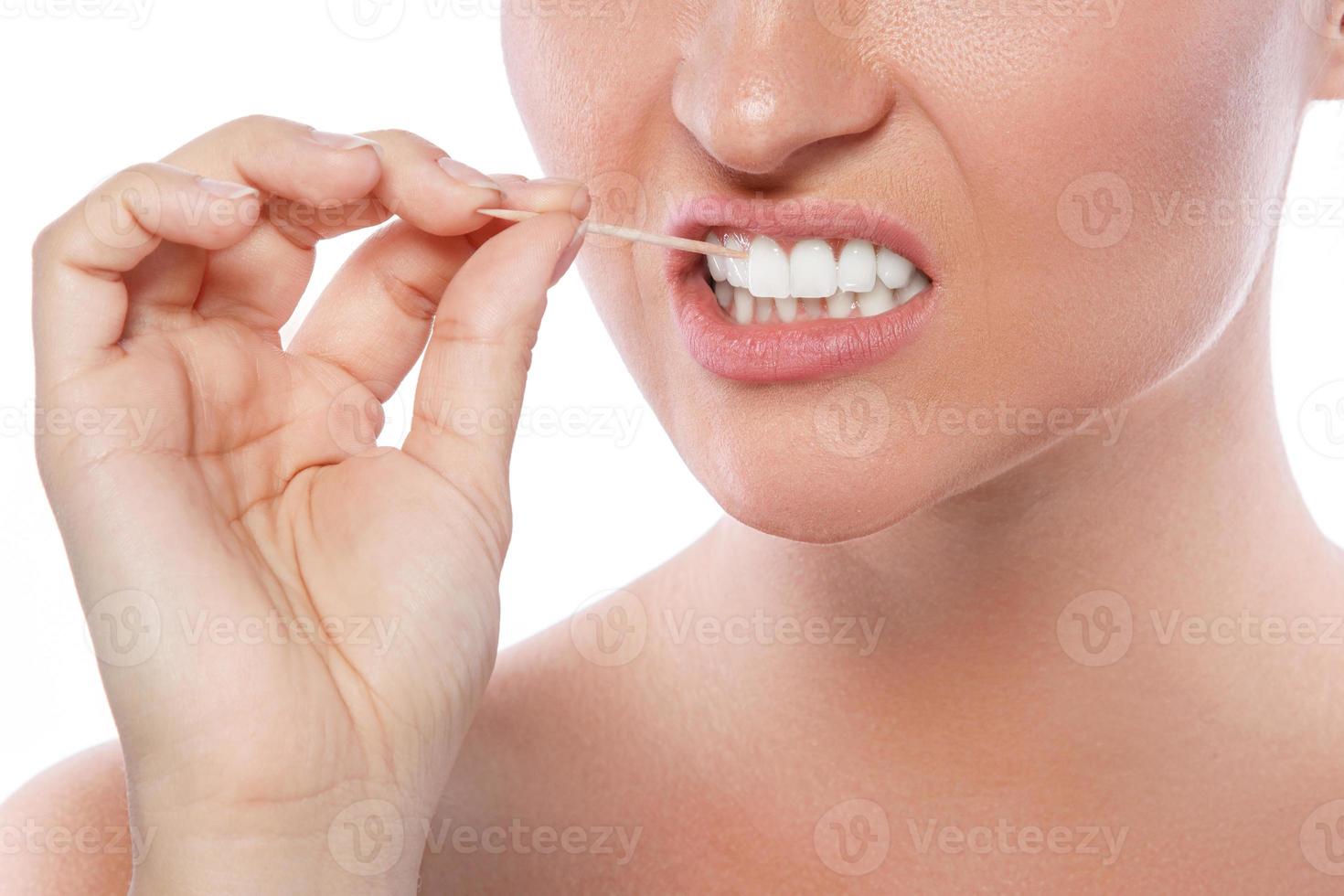 Close up of female teeth and toothpick photo